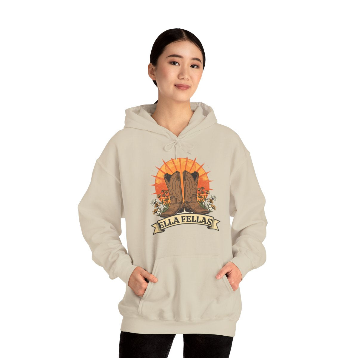 Woman wearing the Ella Fellas Boots and Banner hoodie in sand